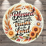 A circular design with a floral border and text that reads "Blessed is the one who trusts in the Lord".