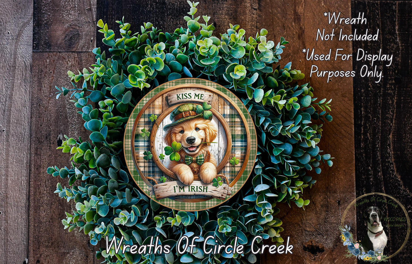 A wreath made of green leaves and a golden retriever dog wearing a green hat and holding a clover.