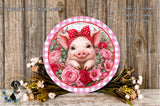 A decorative plate featuring a smiling pig surrounded by a floral arrangement, with a wooden background.
