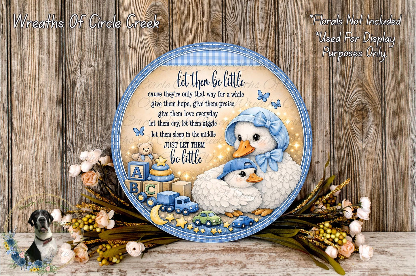 A decorative plate with a baby carriage and two baby ducks, surrounded by flowers and a blue and white checkered border. The plate has a message that reads "Let them be little, cause they're only that way for a while. Give them hope, give them praise, let them love every little thing, let them cry, let them grieve, let them sleep in the middle, just let them be little."