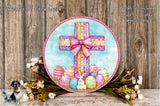 a decorative Easter wreath with a cross, surrounded by colorful Easter eggs and flowers.
