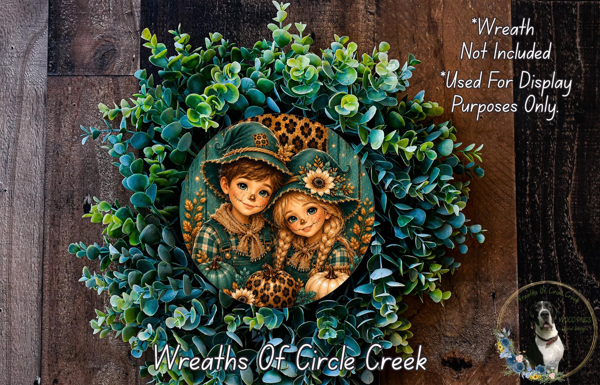 A wreath made of green leaves and flowers, featuring two cartoon-like figures wearing hats. The wreath is displayed on a wooden surface, and there is a small dog in the bottom right corner.