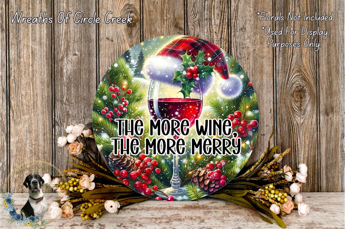 A festive wreath with a wine glass and a Santa hat, surrounded by holiday decorations such as pine cones, berries, and flowers, against a wooden background.
