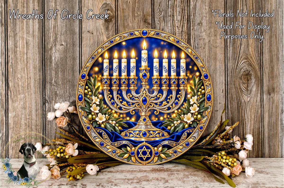a decorative Hanukkah menorah with blue and gold accents, surrounded by flowers and greenery, placed on a wooden surface.