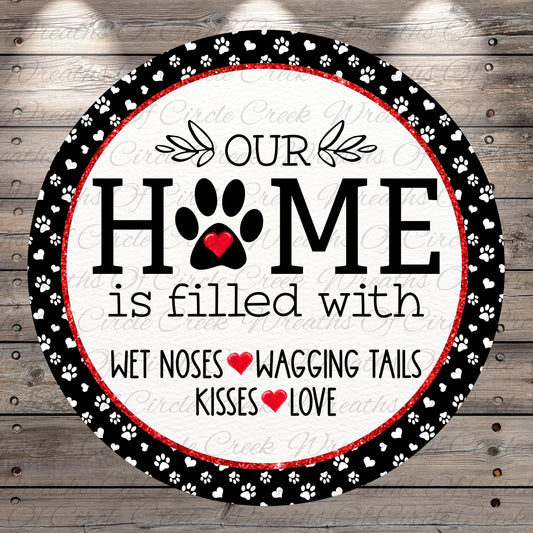 The image is a circular sign with the text "OUR HOME is filled with WET Noses WAGING TAILS KISSES LOVE" written on it.