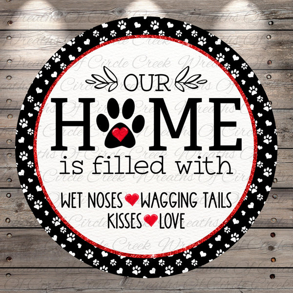 The image is a circular sign with the text "OUR HOME is filled with WET Noses WAGING TAILS KISSES LOVE" written on it.