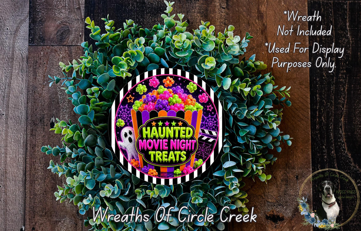 a Halloween-themed wreath made of green leaves and flowers, with a sign that reads "Haunt Movie Night Treats" in the center.
