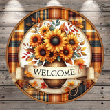 A circular wooden sign with a vase of sunflowers and autumn leaves, surrounded by a plaid border and a banner that says "WELCOME".