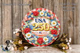 A decorative wreath with flowers and American flags, featuring the text "USA 250" and the year "1776 2026".