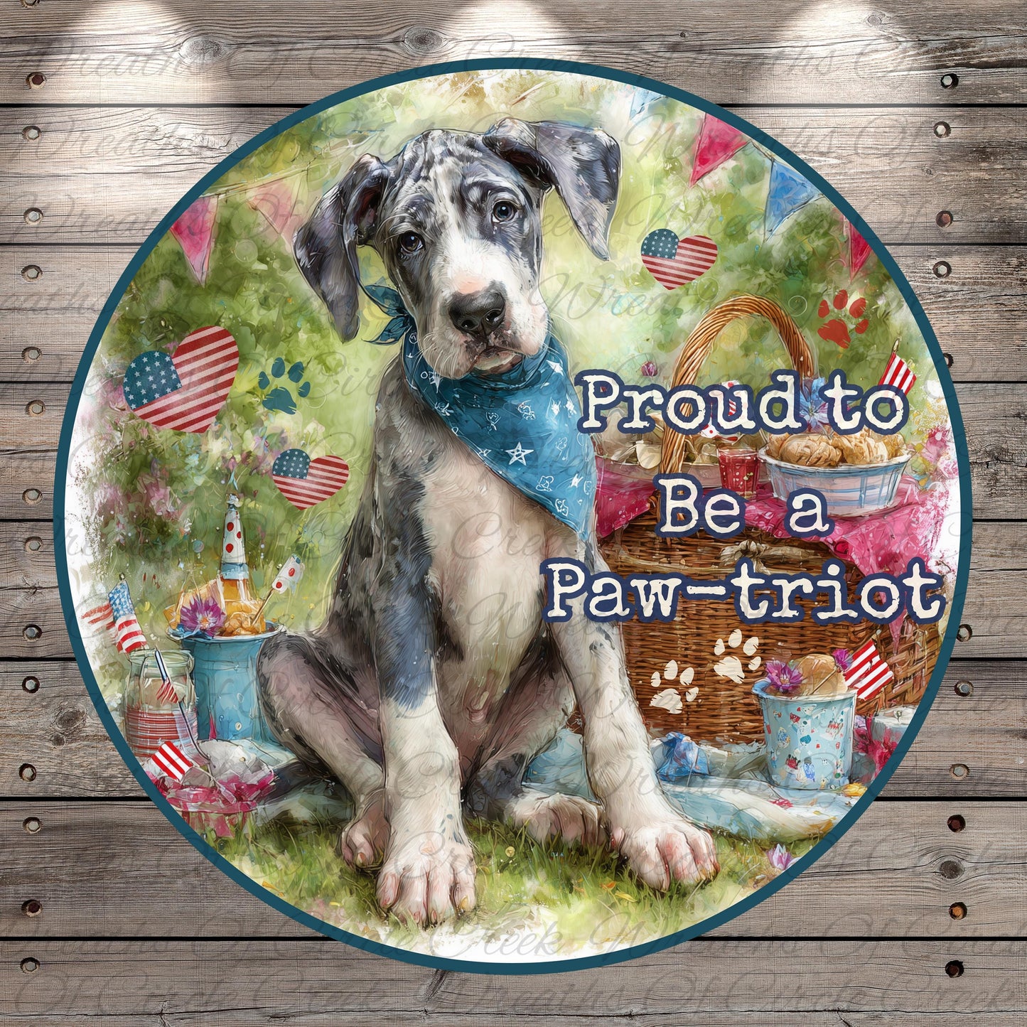 A black and white Great Dane dog wearing a blue bandana, sitting on a grassy area with American flags and a picnic basket nearby.