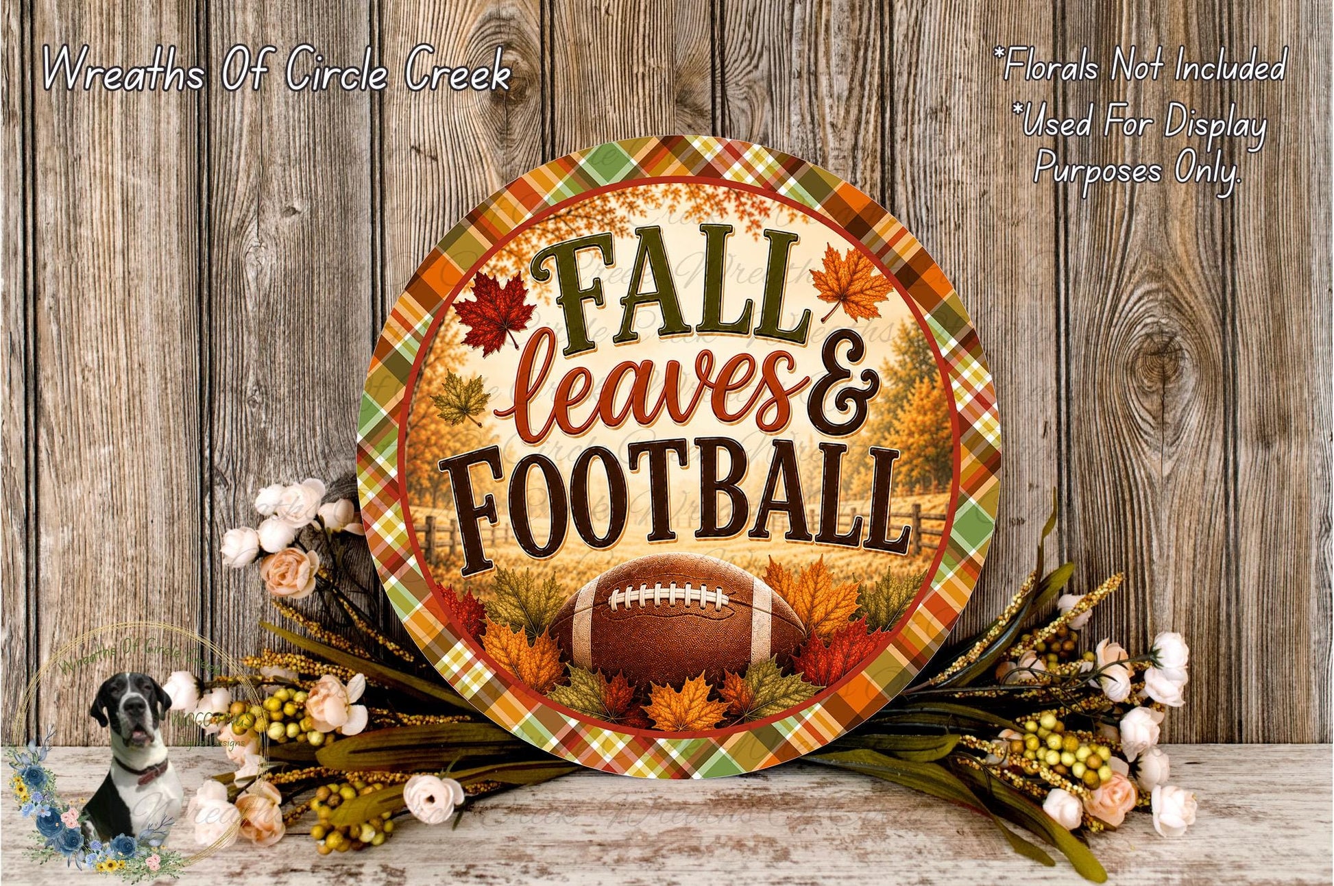 a decorative sign with the text "FALL leaves & FOOTBALL" surrounded by autumn foliage and flowers, placed on a wooden surface.