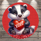 A cute cartoon badger holding a red heart with the word "XOXO" written on it, surrounded by red polka dots on a red background.