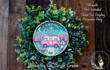 a wreath with a pink camper painted on it