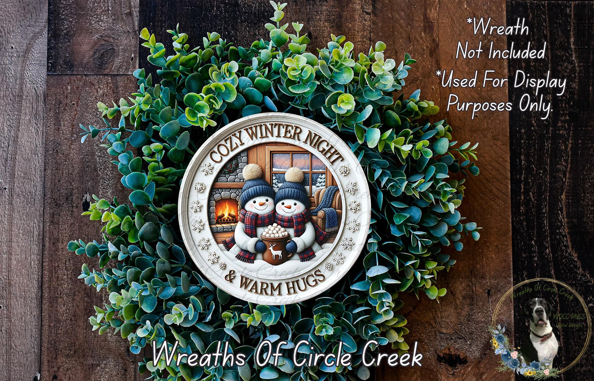 A wreath made of green leaves and featuring a snowman and a fireplace, with the text "COZY WINTER NIGHT & WARM HUGS" displayed on it.