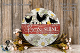 a decorative sign with a floral design and the text "Rise & Shine" on it, placed on a wooden surface. The sign is surrounded by flowers and a wire mesh, creating a rustic and charming atmosphere.