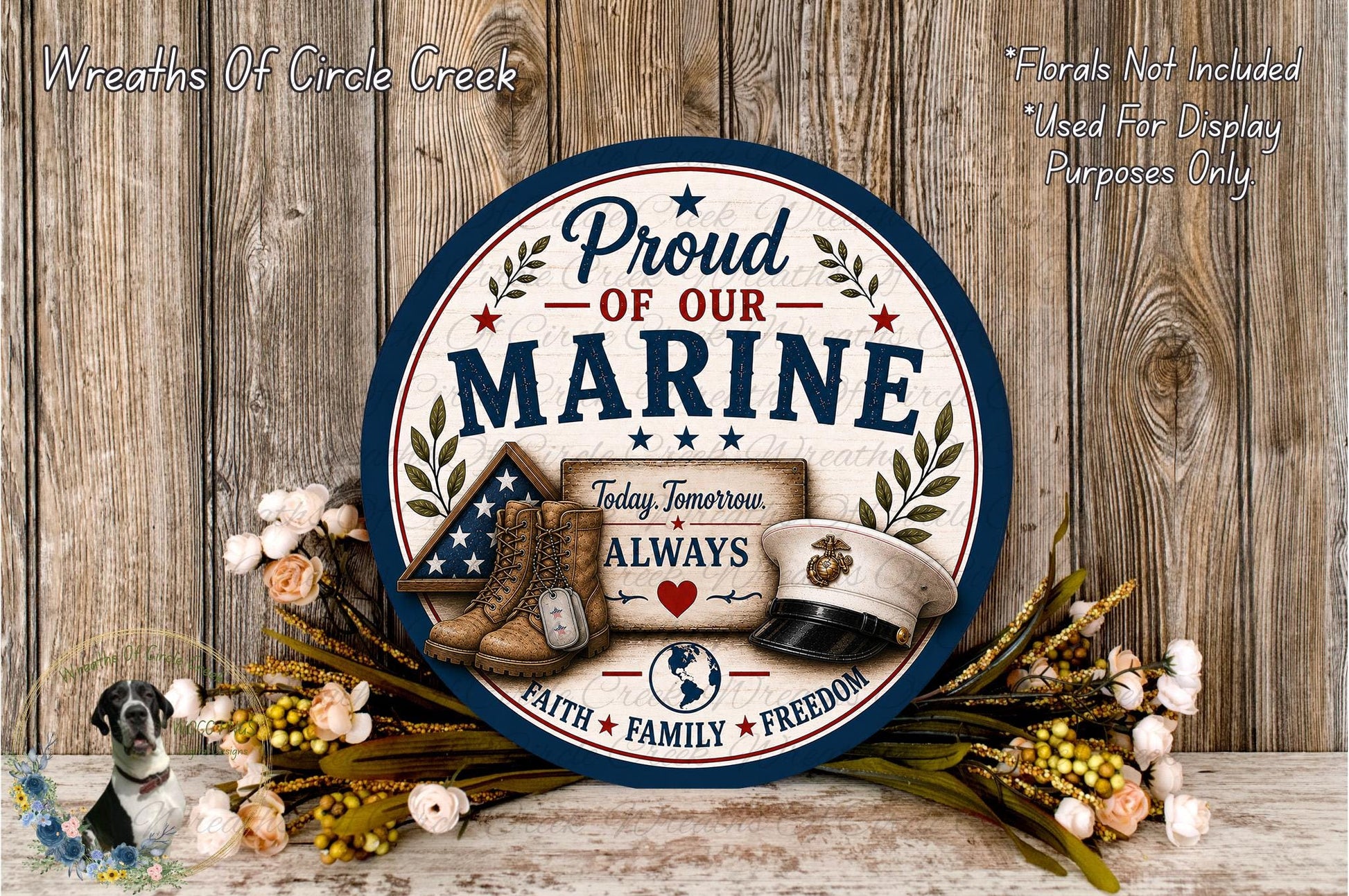a patriotic sign with the text "Proud of our Marine" and various symbols, including a boot, a hat, and a flag, all set against a wooden background.