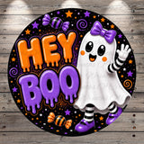 a Halloween-themed graphic with a ghost character and the text "Hey Boo" in a circular design.