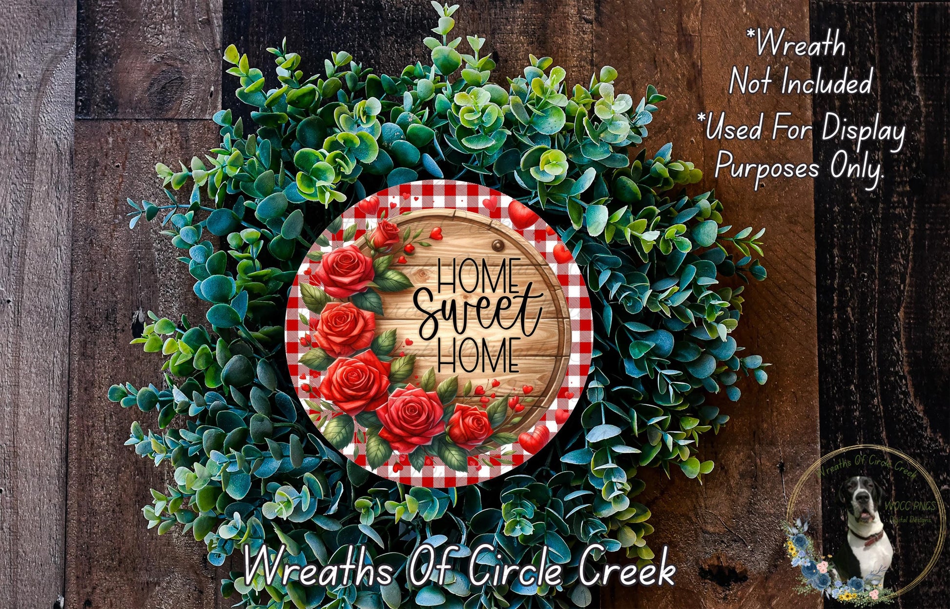 a wreath made of green foliage and red roses, with a wooden sign that reads "Home Sweet Home" in the center.