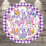 A round sign with a floral design and butterflies, featuring the text "Home Sweet Home" in a decorative font.