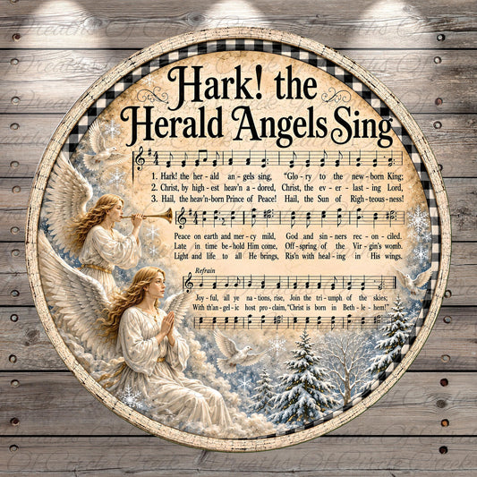 The image is a circular collage featuring a hark! the Herald Angels Sing song, with a snowy winter scene and two angels playing musical instruments.
