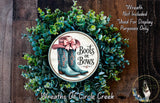a wreath with a decorative border and a pair of boots on a circular plaque, surrounded by a lush green wreath.