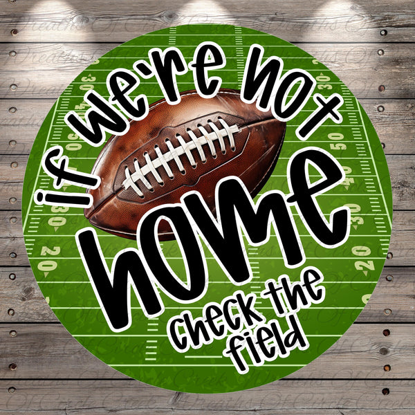 a football on a green football field with the text "If we're not home, check the field" written around it.