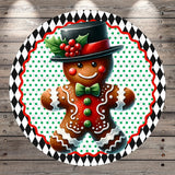A gingerbread man wearing a top hat and bow tie, with a red berry decoration on his hat, is surrounded by a circular frame with a black and white diamond pattern.