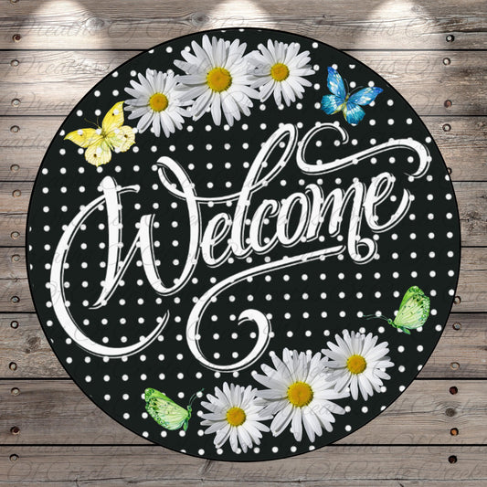 a welcome sign with daisies and butterflies