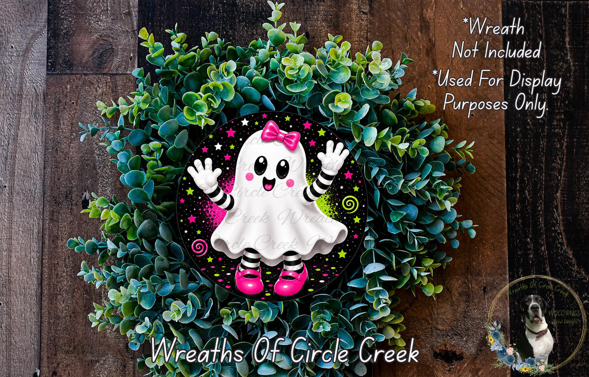 A wreath made of green foliage and featuring a ghost character with pink shoes and a bow, placed on a wooden surface.