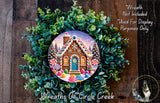 A wreath featuring a gingerbread house surrounded by colorful candy and greenery, with a caption stating that the wreath is not included in a display and is used for purposes only.