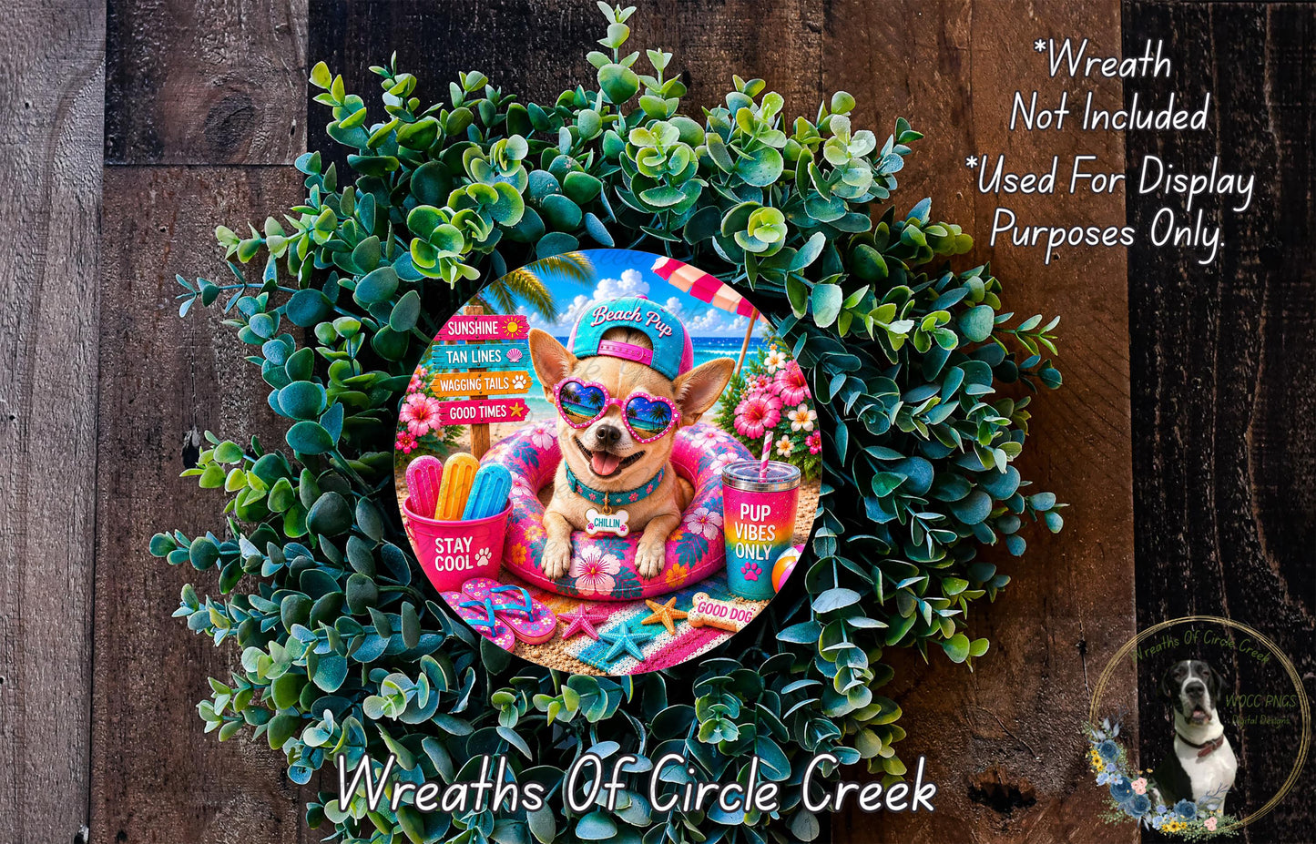 A wreath made of green leaves and flowers, featuring a small dog wearing sunglasses and a hat, surrounded by various colorful objects such as a cup, a beach ball, and a straw.