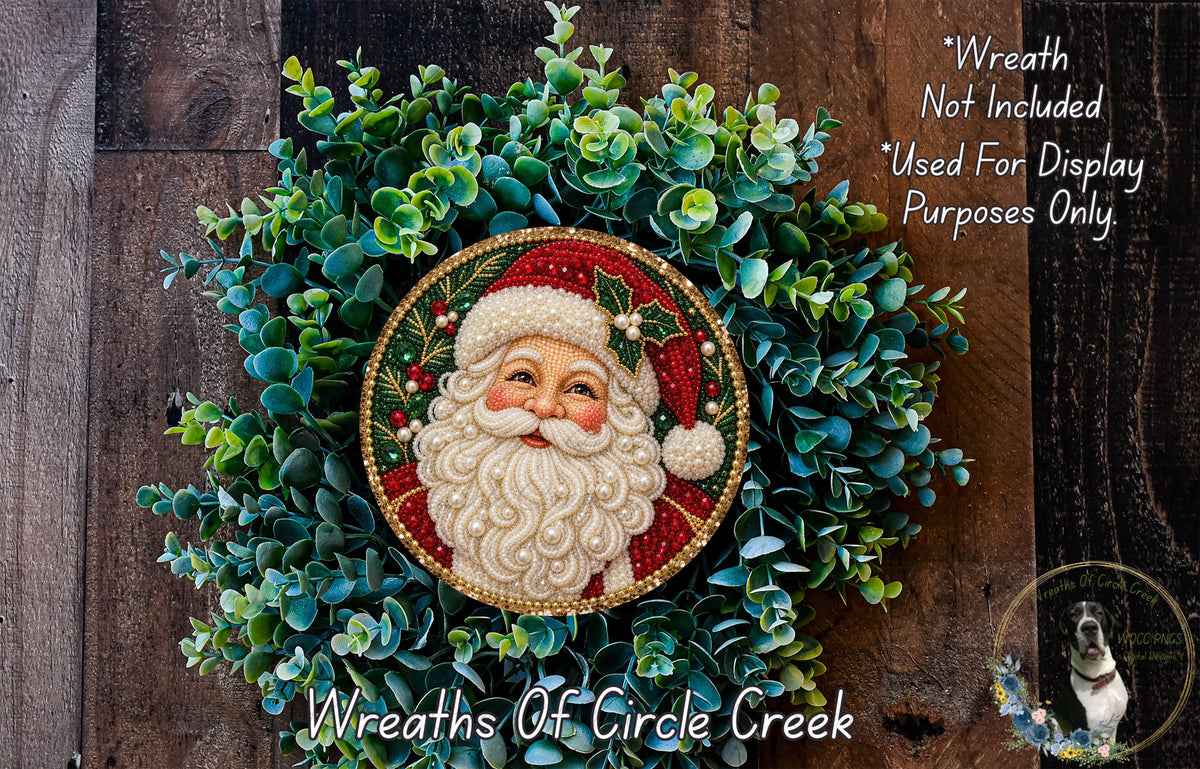 A wreath featuring a Santa Claus face, surrounded by greenery, with a wooden background.