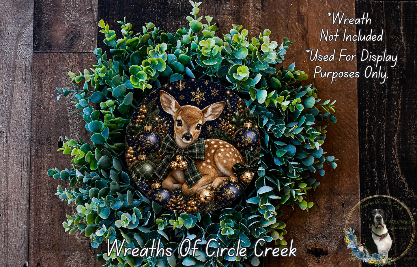 A wreath made of green foliage and adorned with a deer, or a deer-shaped wreath, is displayed on a wooden surface.