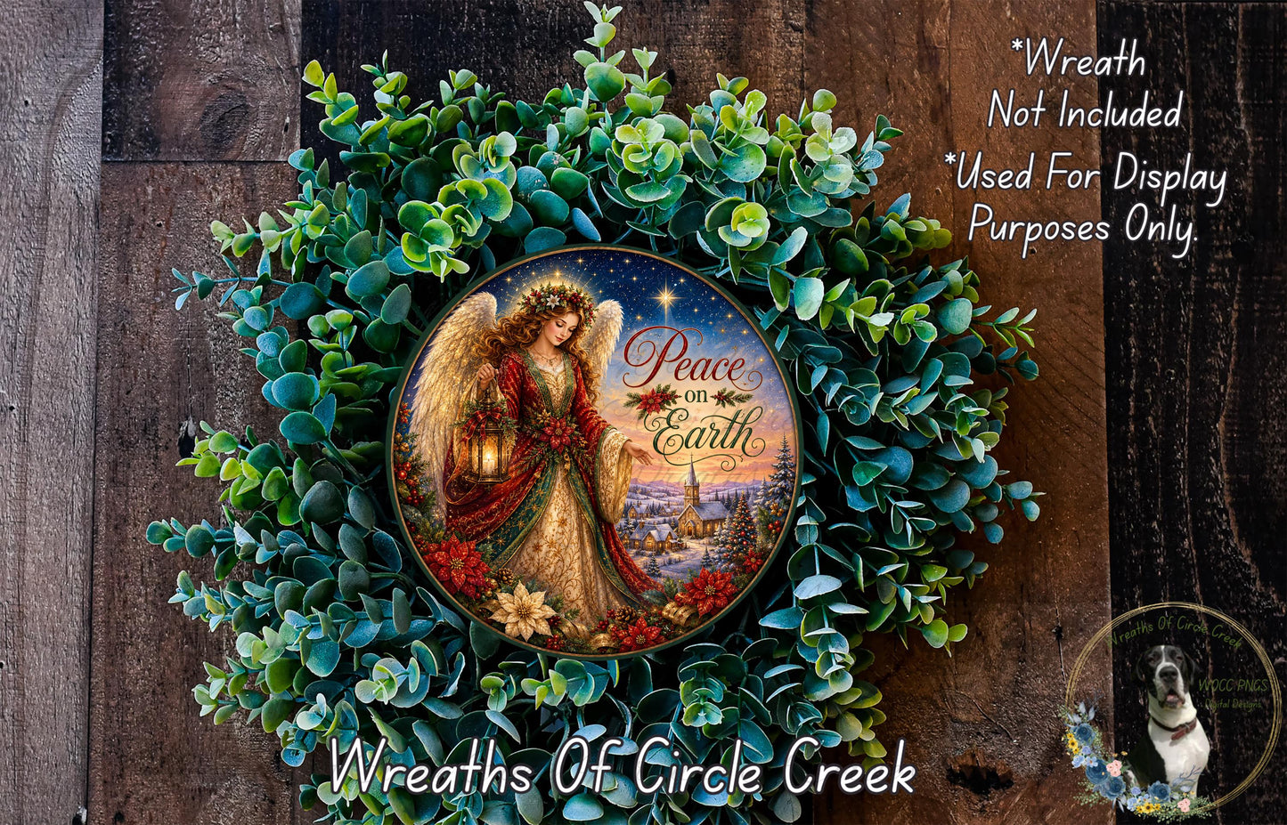 A wreath with a painted angel holding a lantern and the text "Peace on Earth" on it, surrounded by greenery.