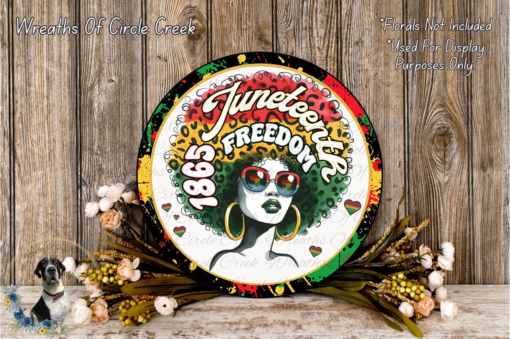 a circular sign with a woman's face and the text "Juneteenth Freedom" on it, surrounded by flowers and a wooden background.
