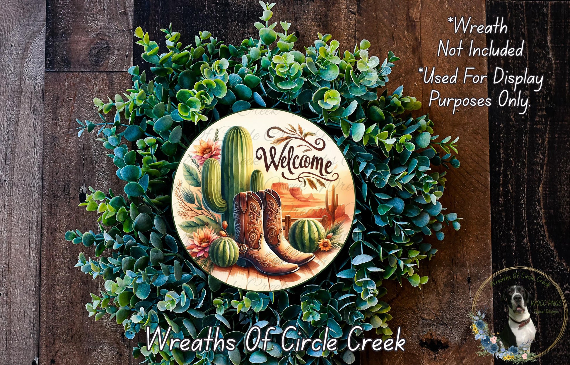 a wreath with a welcome sign, surrounded by various succulents and cacti, including a pair of cowboy boots. The wreath is displayed on a wooden surface, and there is a small dog in the bottom right corner.