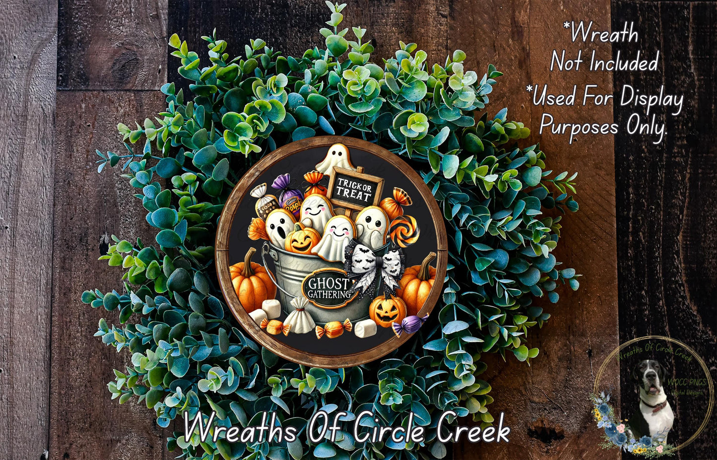 a Halloween-themed wreath made of green foliage and various spooky decorations, including a bucket filled with ghostly figures, pumpkins, and other Halloween-related items.