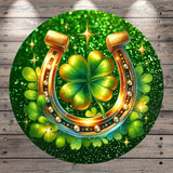 A horseshoe with a four-leaf clover on top, surrounded by green leaves and sparkling lights, all set against a green background.