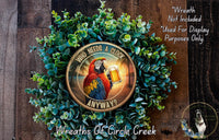a wreath with a parrot holding a glass of beer