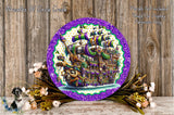a round, purple-rimmed plate with a detailed illustration of a pirate ship on a wooden background. The plate is surrounded by a wreath of flowers and a wooden wall.