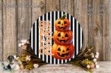 a Halloween-themed decoration with a black and white striped background, a circular arrangement of three jack-o'-lanterns, and a floral arrangement on the side.