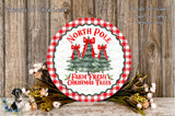 a festive Christmas tree wreath with the text "North Pole" and "Farm Fresh Christmas Trees" displayed on it, surrounded by a floral arrangement and a wooden background.