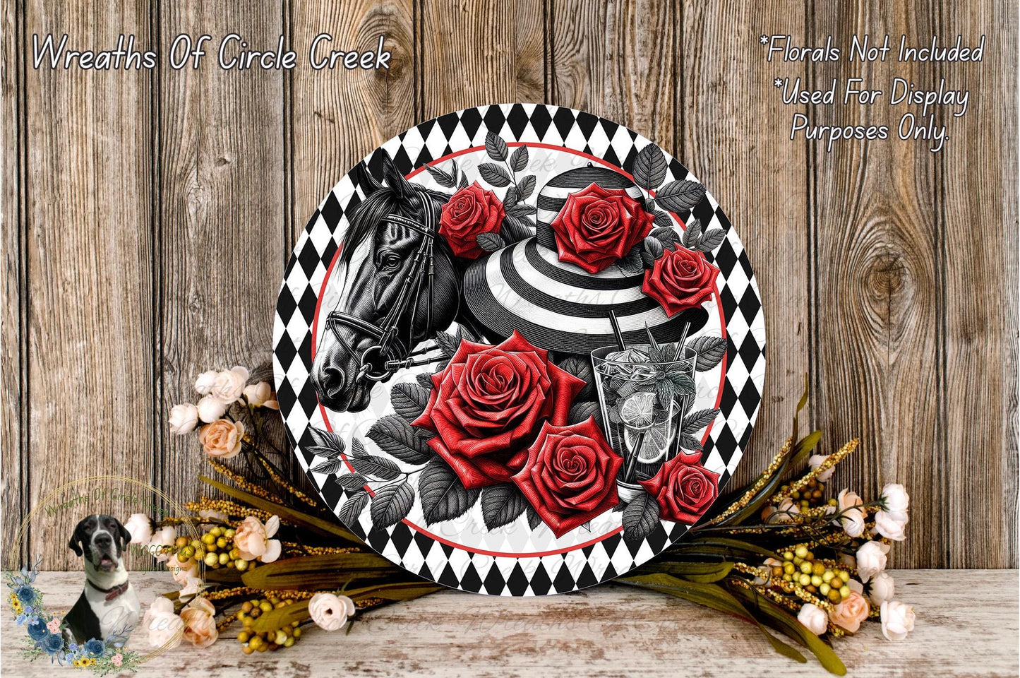 a decorative plate with a black and white design, surrounded by red roses and greenery. The plate is placed on a wooden surface, and there are additional flowers and greenery nearby.