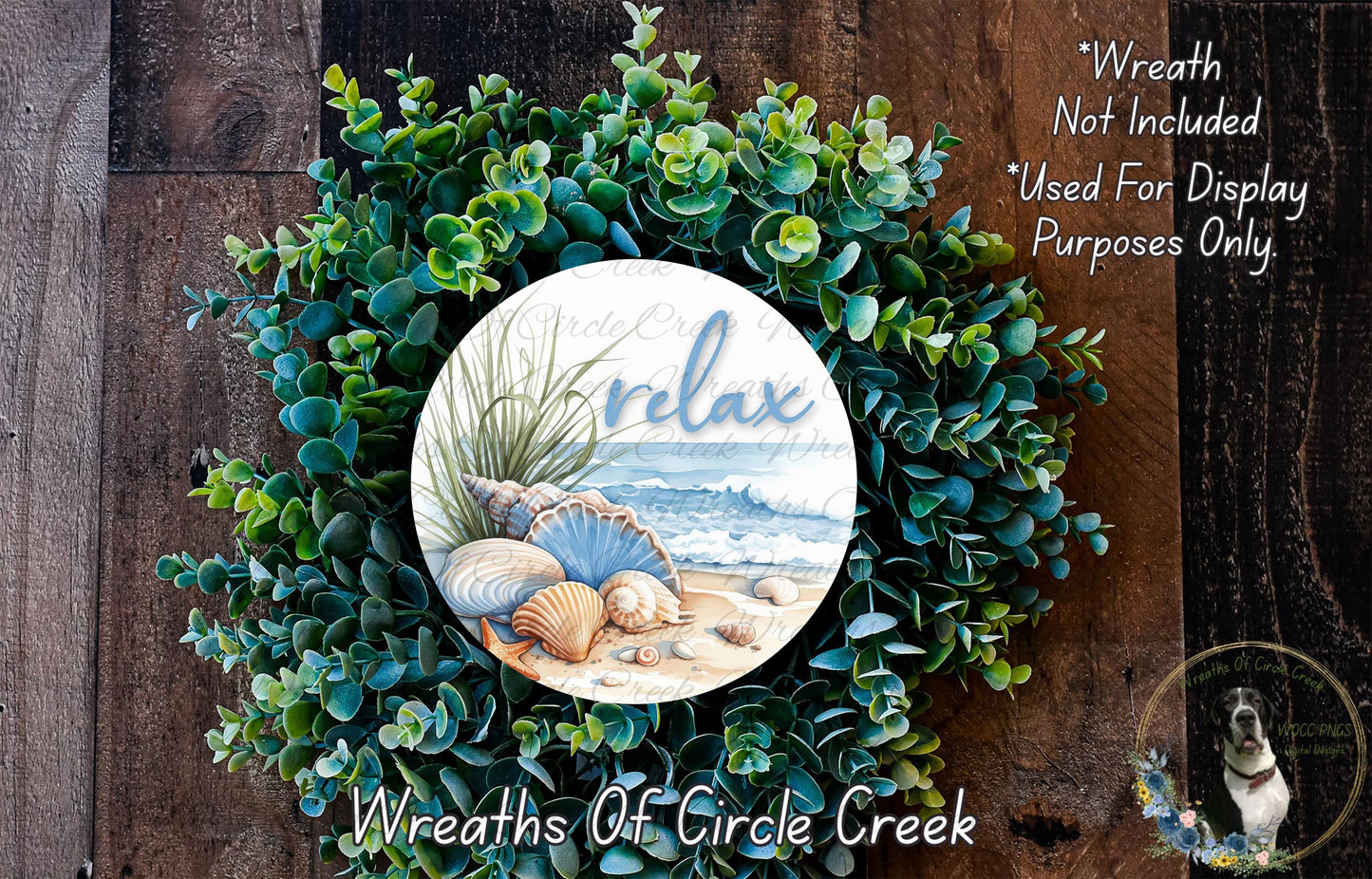 A wreath made of various green plants and seashells, with a circular design featuring the word "relax" and an illustration of a beach scene.