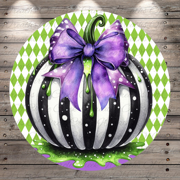 A whimsical illustration of a black and white striped pumpkin with a purple bow, set against a green and white diamond patterned background.