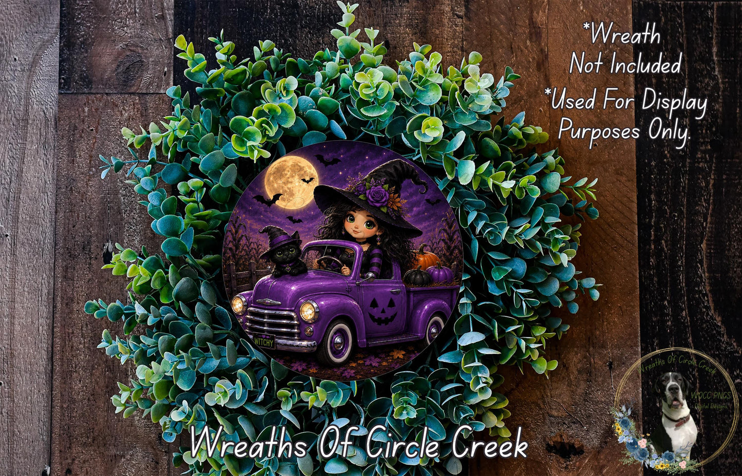 A Halloween-themed wreath featuring a purple truck with a witch and a pumpkin, surrounded by green foliage and a full moon.