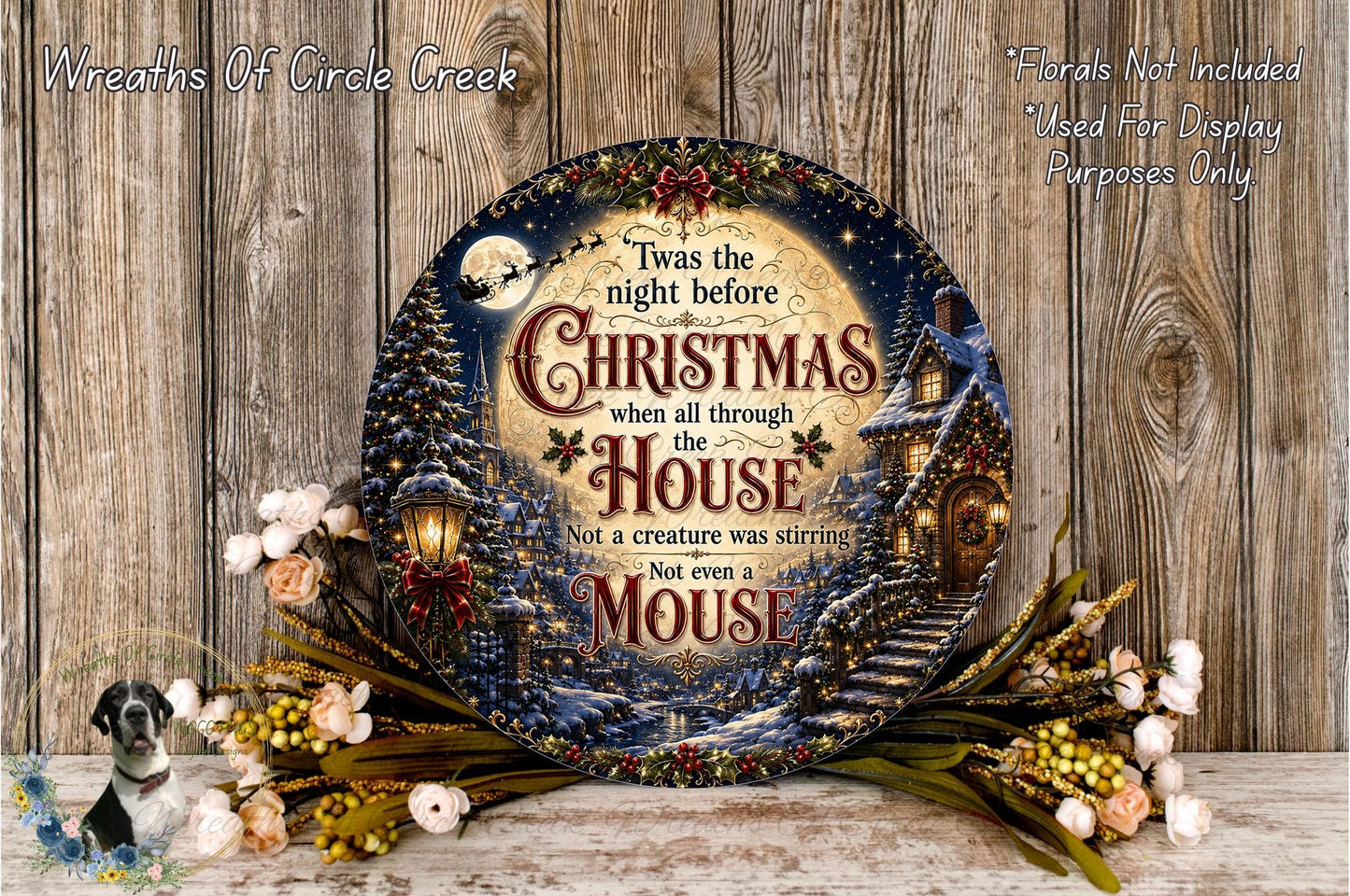 a decorative Christmas wreath with a whimsical scene of a mouse and a house, surrounded by flowers and greenery.