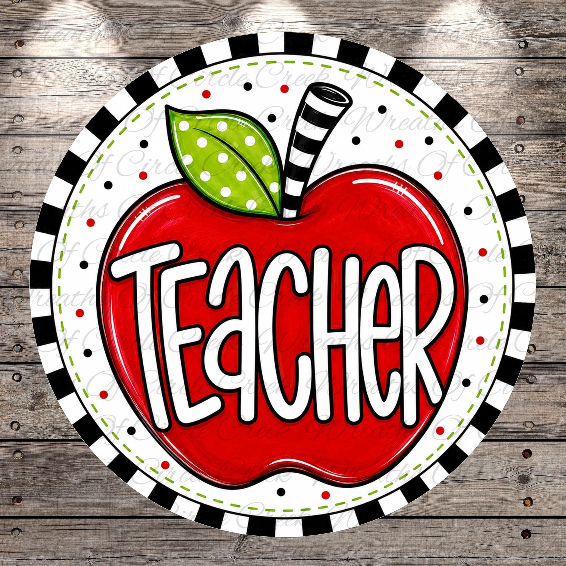 A red apple with the word "Teacher" written on it, surrounded by a black and white striped border.