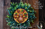 A decorative wreath made of green foliage and featuring a colorful, plaid-patterned turkey design at the center.