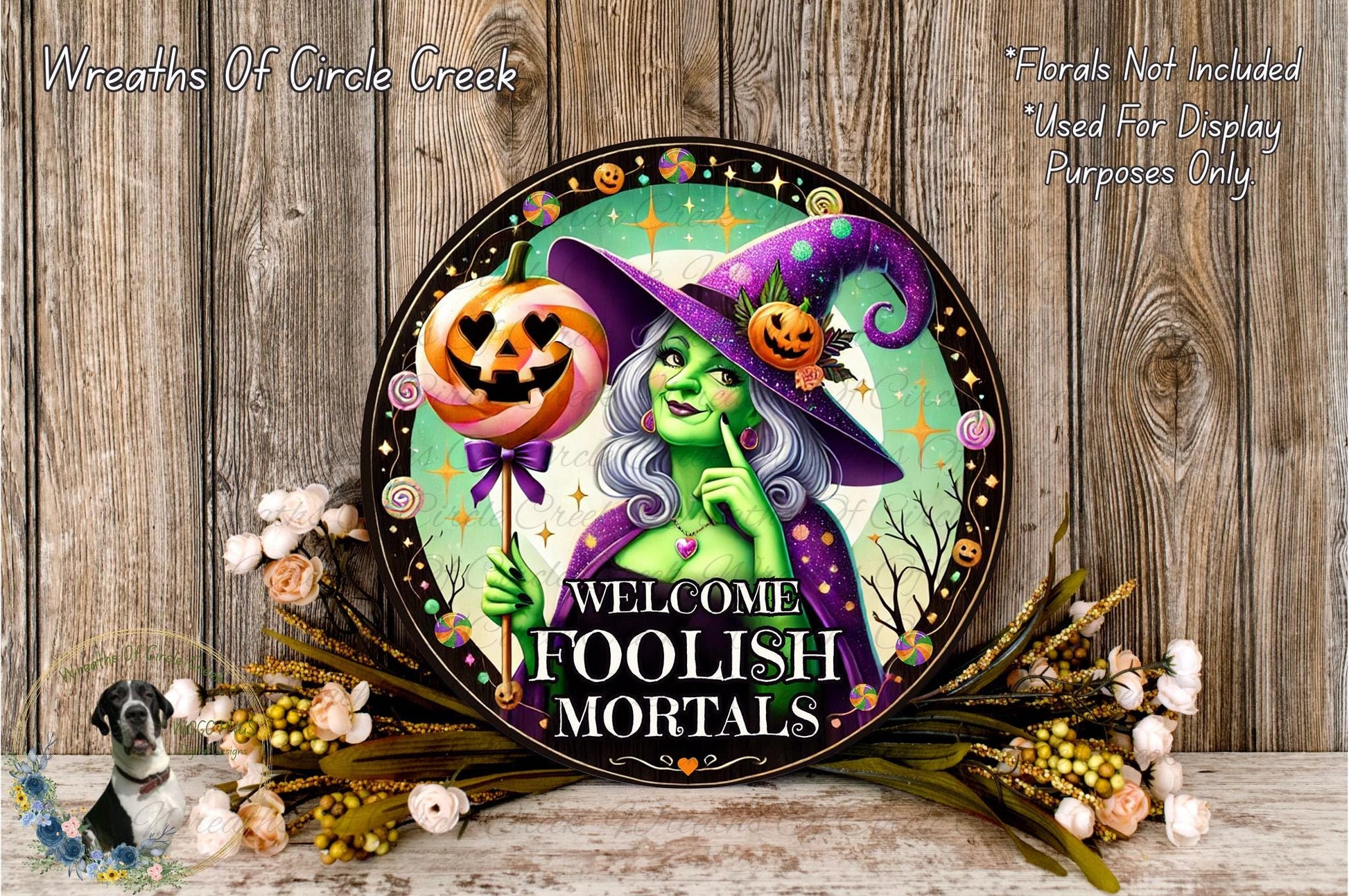 a picture of a welcome sign with a witch and pumpkin
